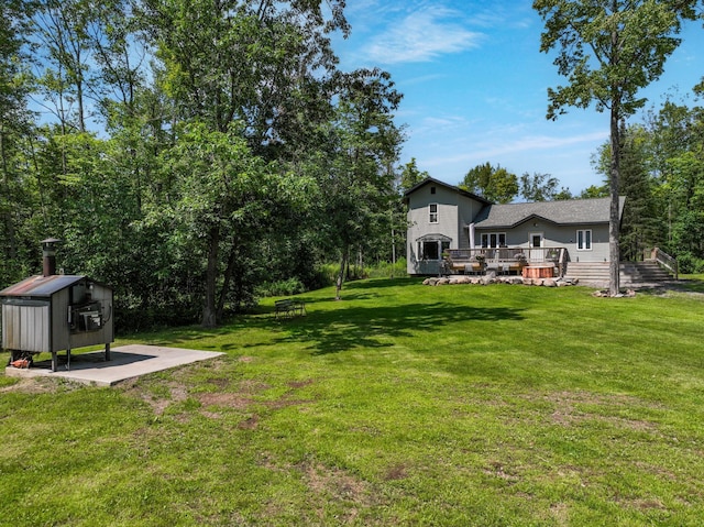 view of yard with an outdoor structure and a wooden deck