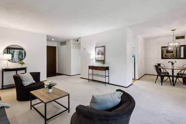 carpeted living room featuring an inviting chandelier