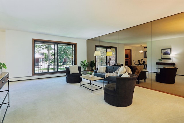 carpeted living room featuring a notable chandelier and a baseboard radiator