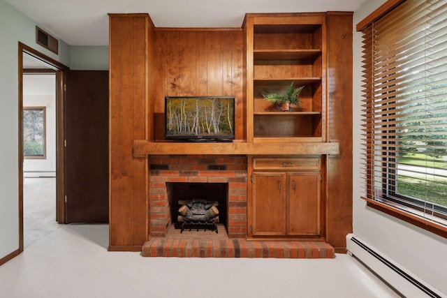 living room with light colored carpet, a brick fireplace, and a baseboard heating unit