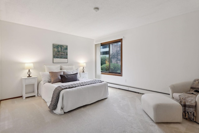 bedroom with a textured ceiling, baseboard heating, and light carpet