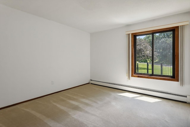 unfurnished room featuring light carpet and a baseboard heating unit