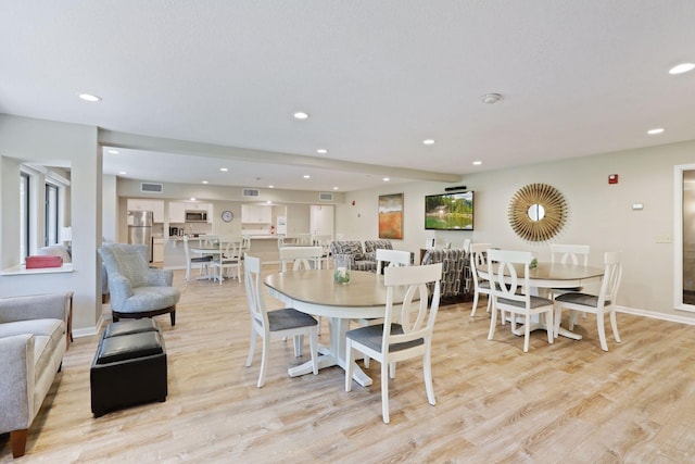 dining space with light hardwood / wood-style flooring