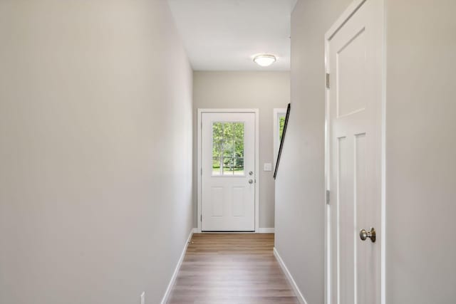 corridor with hardwood / wood-style floors