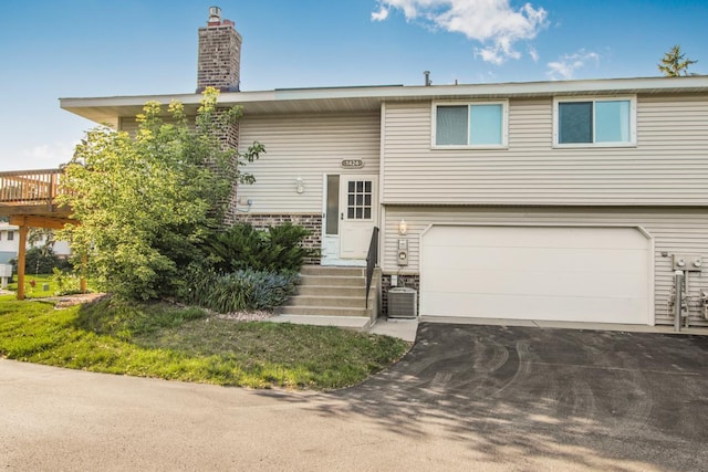 split foyer home with a garage and central AC