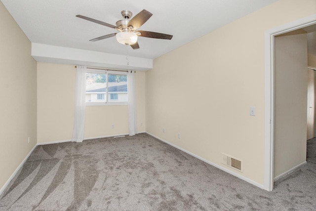 carpeted spare room with ceiling fan