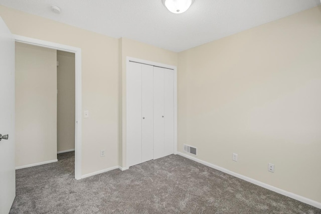 unfurnished bedroom featuring a closet and carpet floors