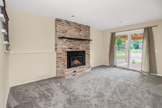 unfurnished living room featuring carpet flooring and a brick fireplace