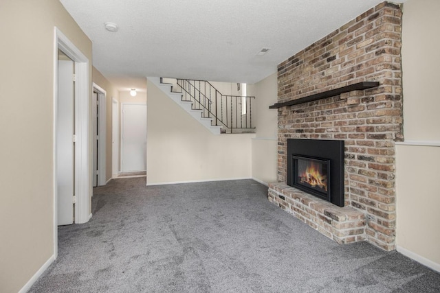 unfurnished living room with a fireplace, a textured ceiling, and carpet flooring