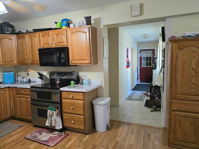 kitchen featuring stainless steel range with electric cooktop and light hardwood / wood-style flooring