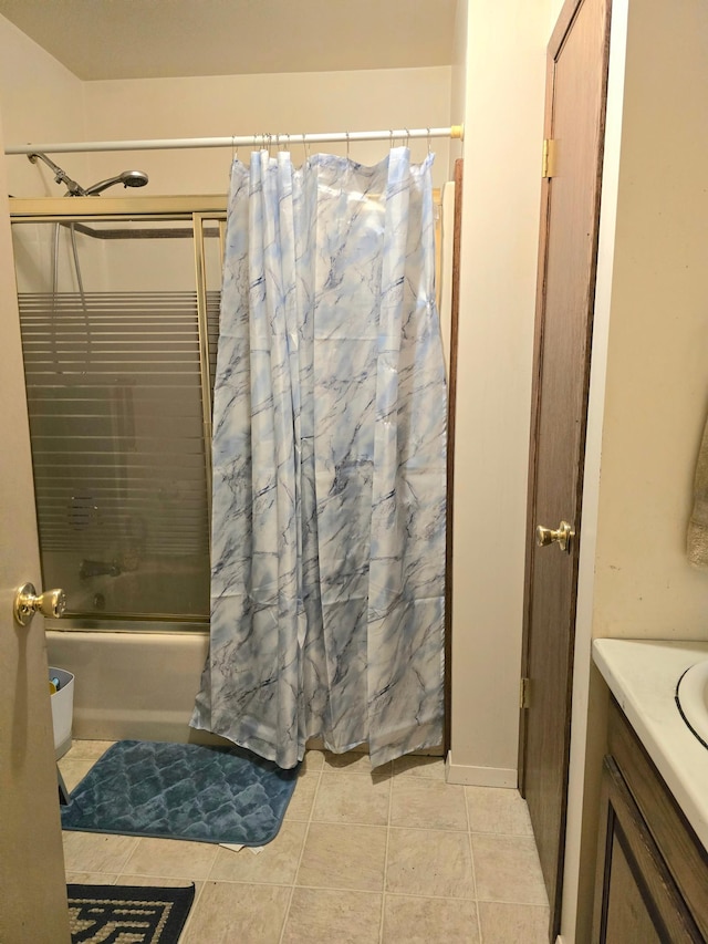 bathroom with shower / tub combo, vanity, and tile patterned floors