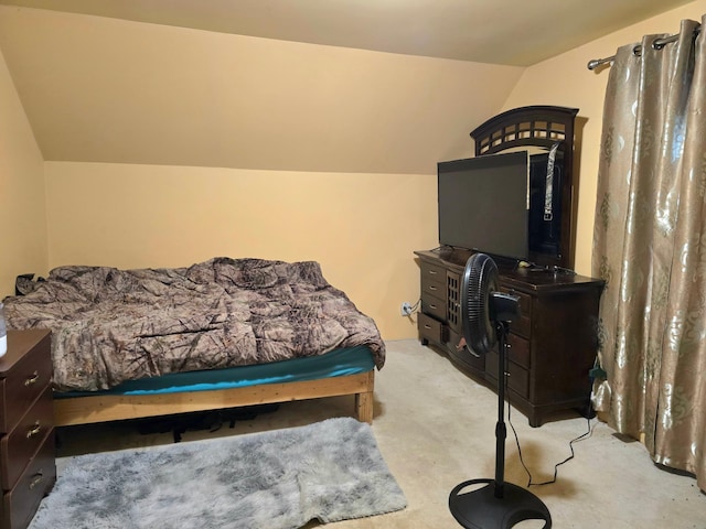 bedroom with vaulted ceiling and light carpet