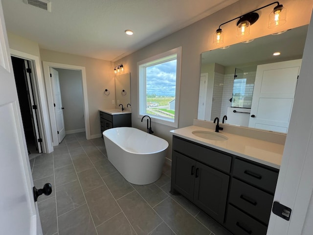 bathroom with vanity, tile patterned floors, and shower with separate bathtub