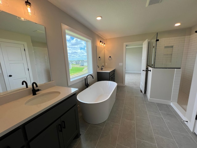 bathroom featuring vanity, separate shower and tub, and tile patterned floors