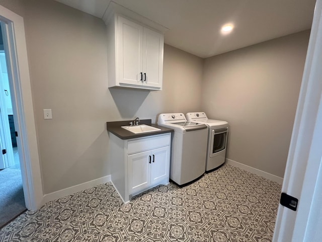 laundry room with cabinets, sink, and washer and dryer