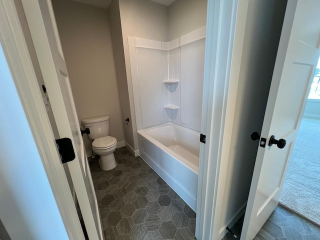 bathroom with shower / bathing tub combination, tile patterned floors, and toilet