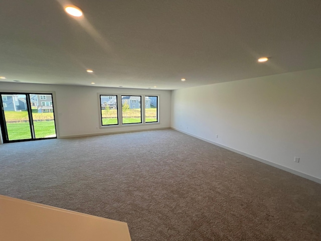 carpeted spare room featuring plenty of natural light and recessed lighting