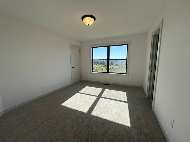 unfurnished bedroom with baseboards, visible vents, and carpet