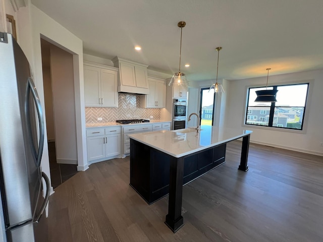 kitchen with tasteful backsplash, light countertops, premium range hood, appliances with stainless steel finishes, and dark wood-style floors