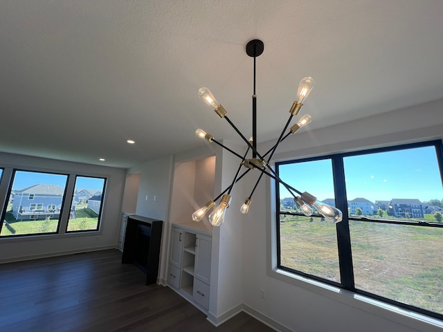 interior details featuring baseboards, a notable chandelier, wood finished floors, and recessed lighting
