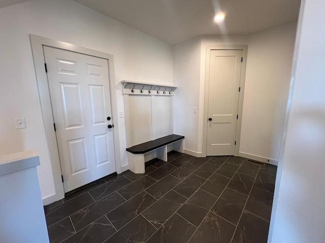 mudroom featuring baseboards and marble finish floor