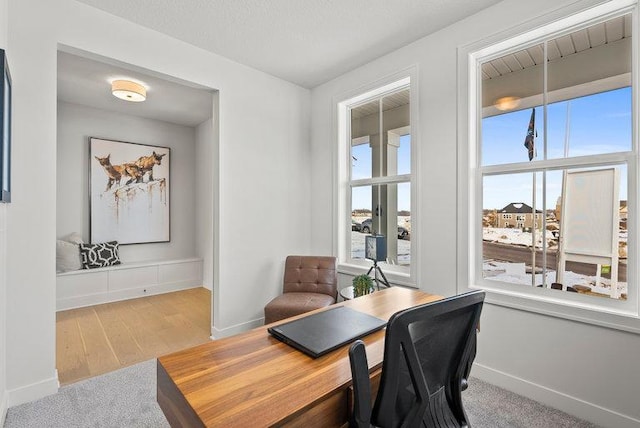 office area with baseboards and wood finished floors