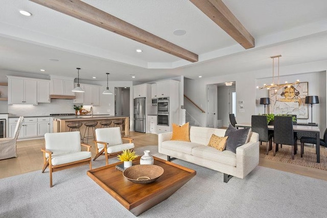 living room featuring stairway, recessed lighting, beam ceiling, and light wood-style floors