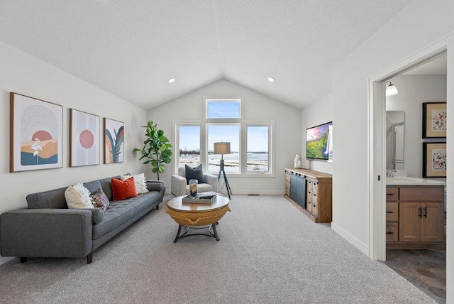 carpeted living area featuring lofted ceiling, baseboards, and a textured ceiling