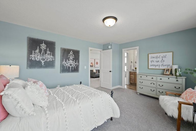 bedroom with carpet floors, ensuite bath, and baseboards