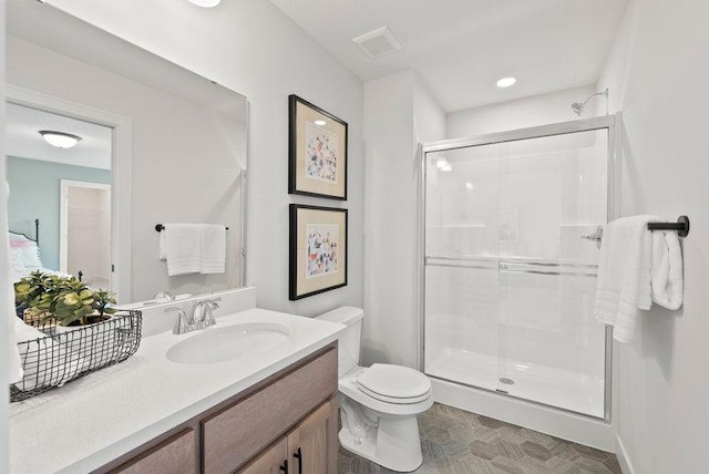 bathroom featuring visible vents, toilet, a shower stall, and vanity