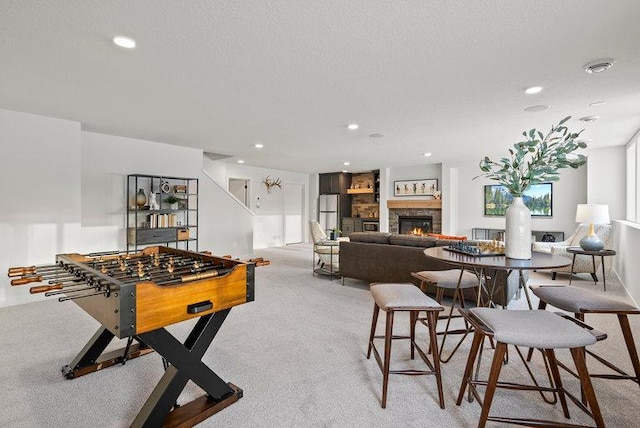 playroom with a fireplace, carpet flooring, and recessed lighting