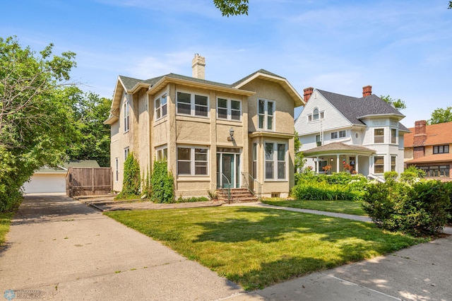 view of front of property with a garage and a front yard