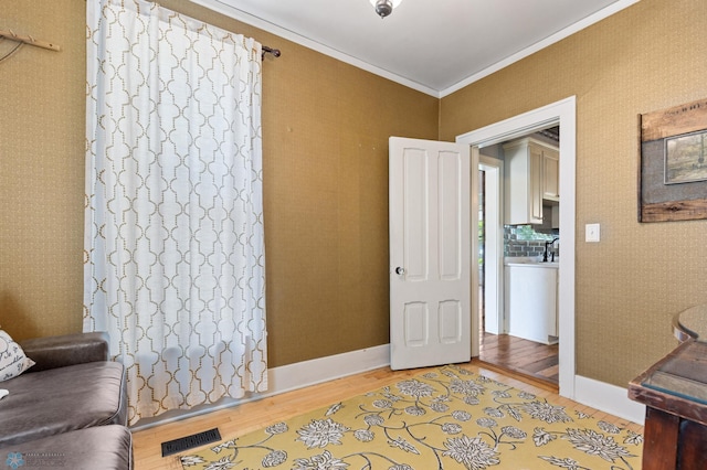 office area with crown molding and wood-type flooring