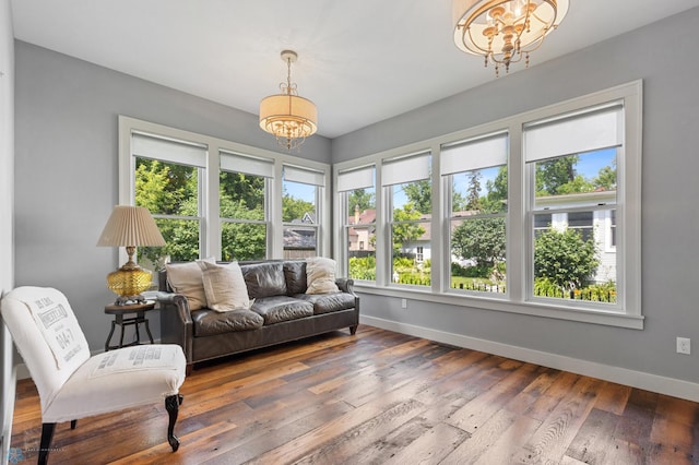 sunroom / solarium with a notable chandelier