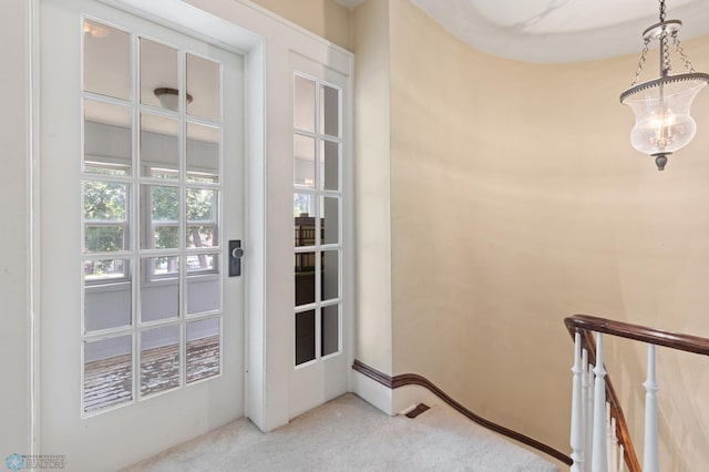 entryway featuring light carpet