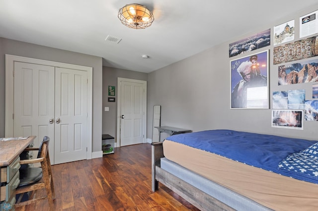 bedroom with a closet and dark hardwood / wood-style floors