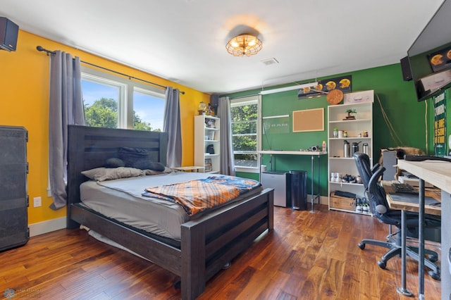 bedroom with dark wood-type flooring