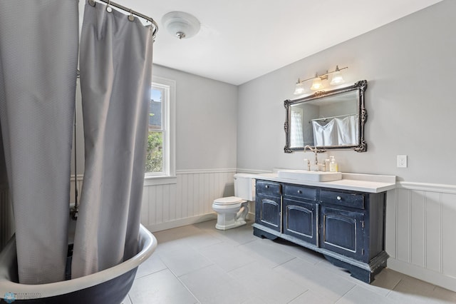 bathroom featuring tile patterned floors, vanity, and toilet