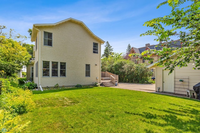 back of house with a deck and a lawn