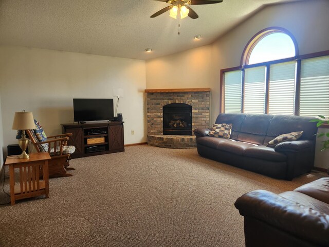 carpeted living room with ceiling fan, a textured ceiling, a fireplace, and vaulted ceiling