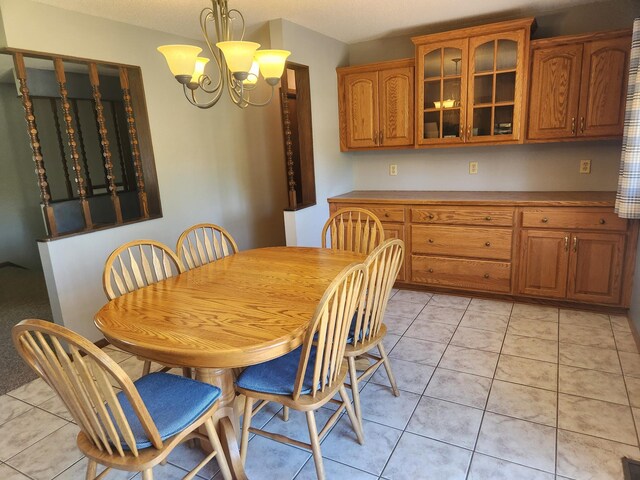 tiled dining space with an inviting chandelier