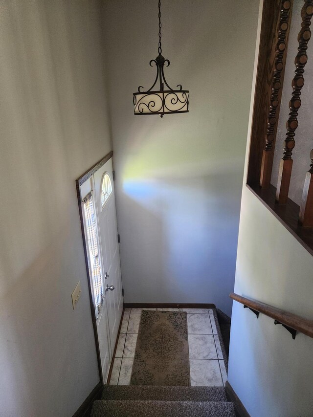 stairway with tile patterned floors