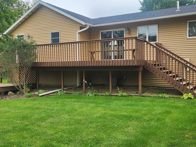 back of property featuring a lawn and a deck