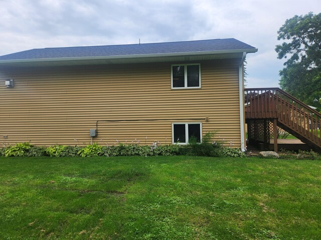 view of home's exterior with a lawn and a wooden deck