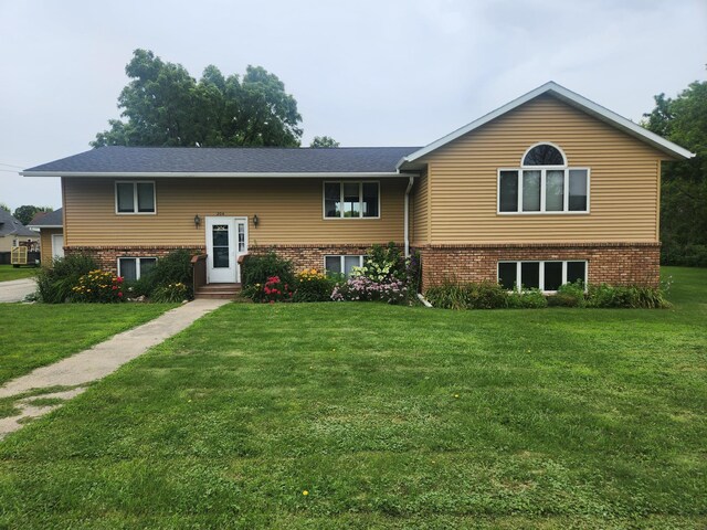 raised ranch with a front lawn