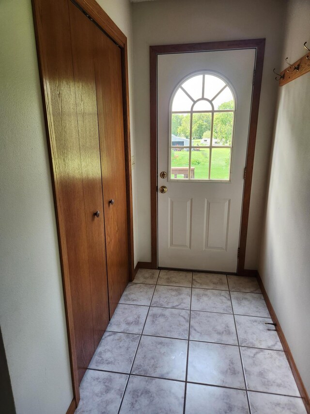 entryway with light tile patterned floors