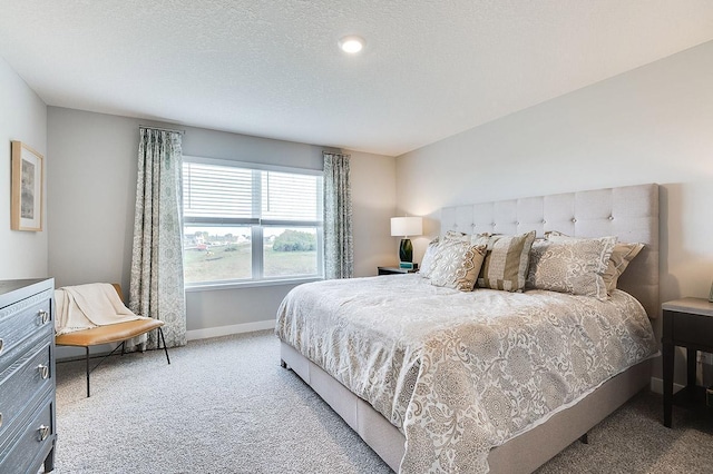 bedroom with a textured ceiling and carpet floors