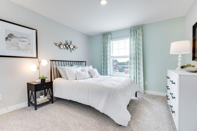 bedroom featuring light colored carpet