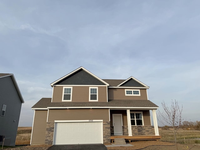 view of front of property featuring a porch and a garage