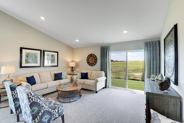 carpeted living room featuring vaulted ceiling